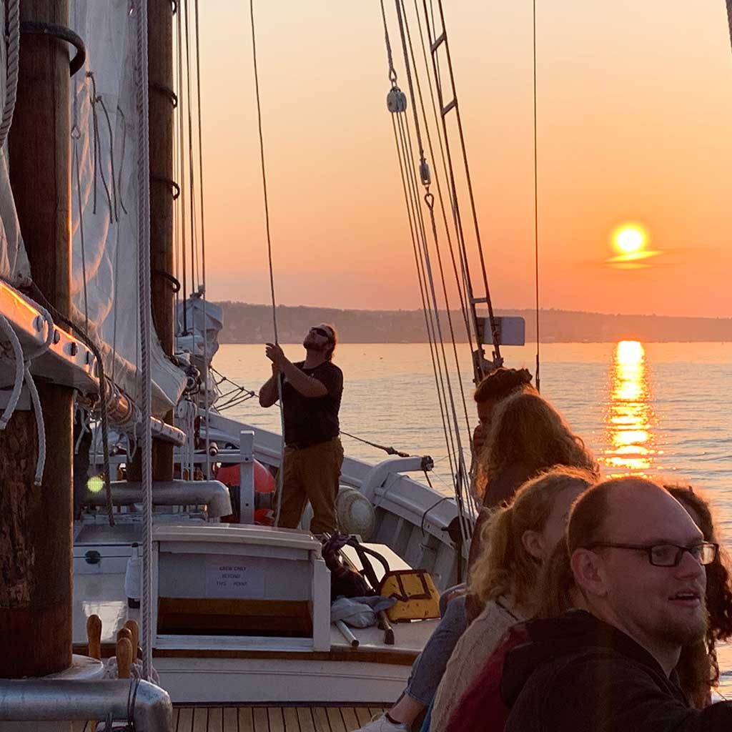 Tending the sails at sunset